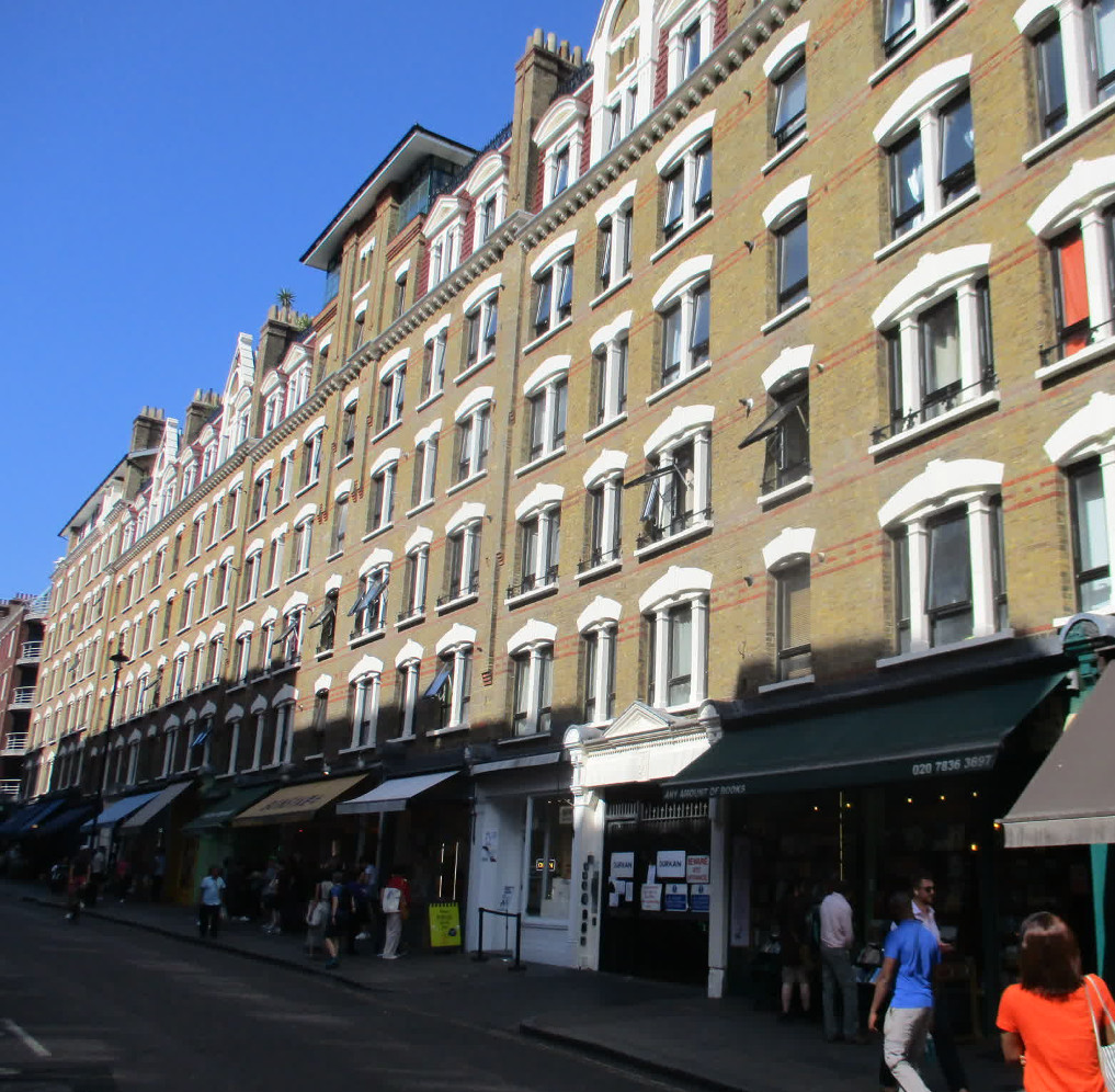 Sandringham Flats facing Charing Cross Road, bright sunlight and shadows on shop fronts